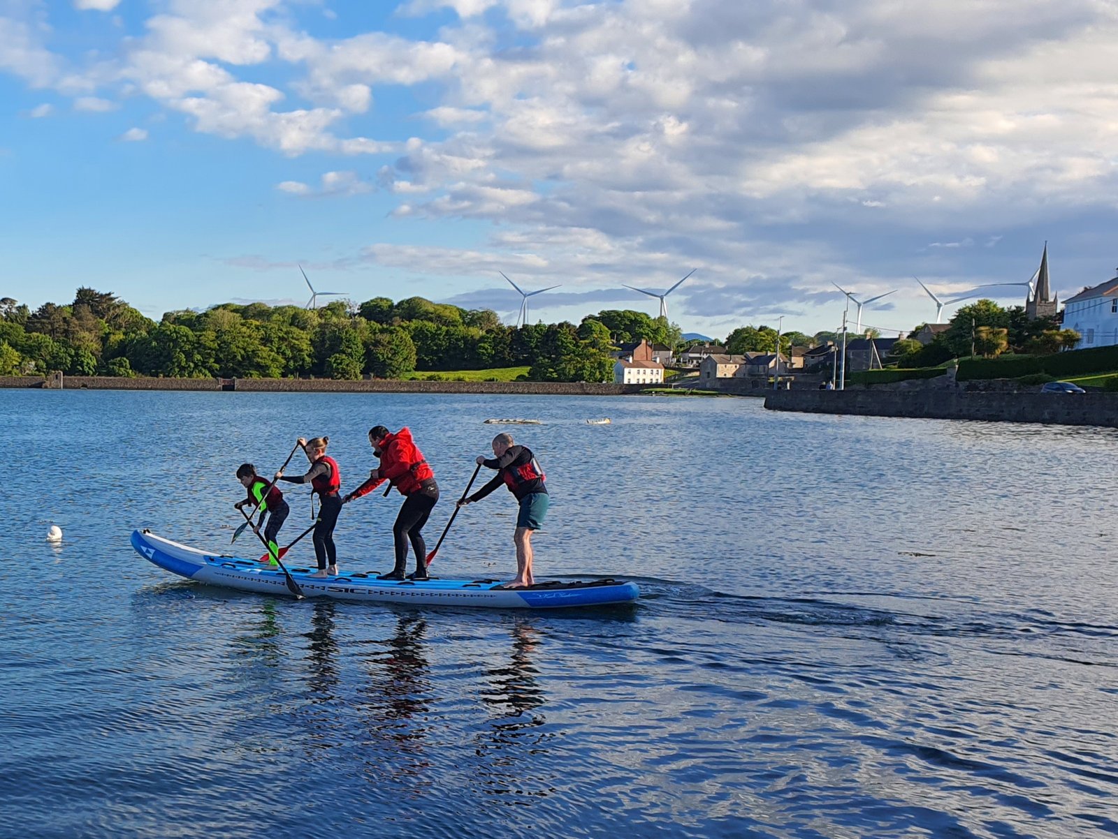Four people on a monster sup out of the water at Killala pier